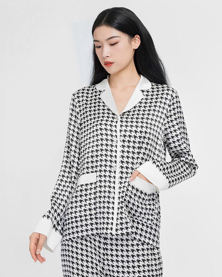 A person with long black hair is wearing the Houndstooth Silk Pajamas Set by SusanSilk against a plain white background.