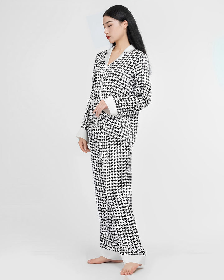 A person stands barefoot wearing the Houndstooth Silk Pajamas Set by SusanSilk.