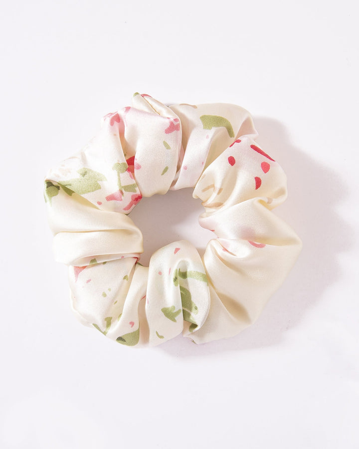 Cream-colored scrunchie from the SusanSilk Lovely Flowers Silk Scrunchies Set 3-Pack, adorned with a floral pattern in pink and green accents, displayed against a white background.