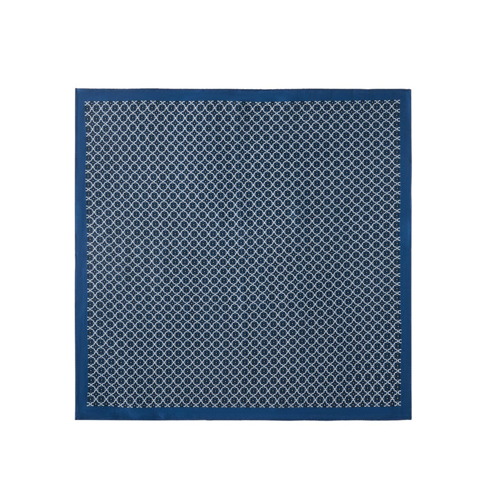 The luxurious Lucky Clover Square Silk Scarf by SusanSilk, crafted from sumptuous silk, features a repeating circular white pattern against a blue background and a solid blue border.