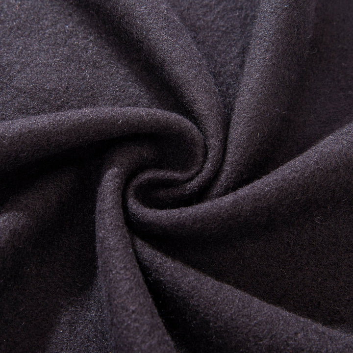 Close-up of the Mix Pattern Long Silk Brushed Scarf by SusanSilk, showcasing its black silk fabric with a central swirl pattern. The texture appears soft and smooth.