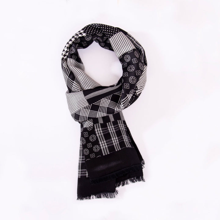 A Mix Pattern Long Silk Brushed Scarf by SusanSilk, featuring a black and white geometric design, neatly folded and placed on a plain white background.