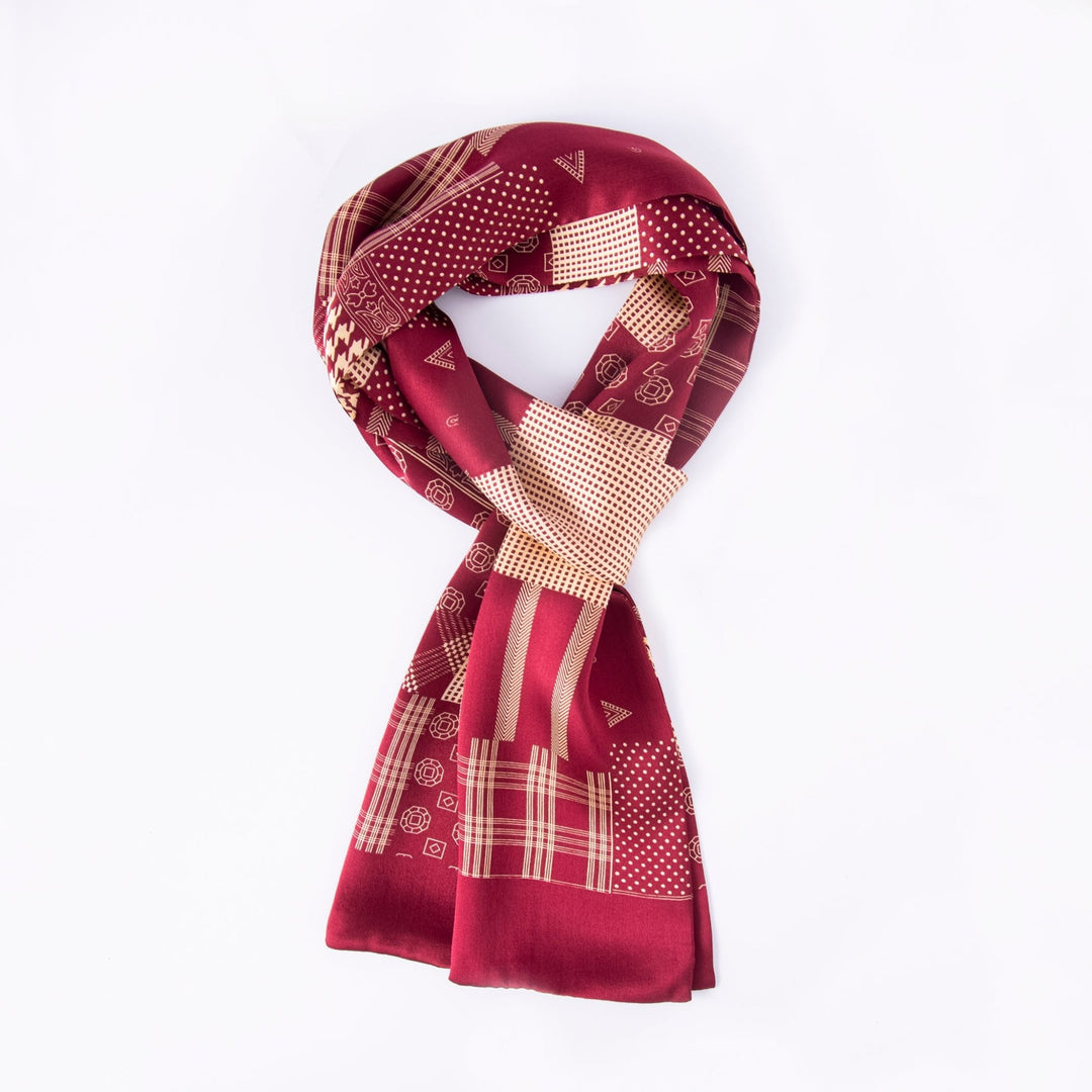 The Mix Pattern Long Silk Scarf by SusanSilk, featuring luxurious geometric and plaid designs in a rich red color, is elegantly laid out on a plain white background to highlight its exquisite craftsmanship.