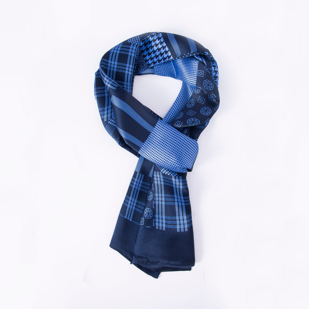 The Mix Pattern Long Silk Scarf from SusanSilk showcases an array of blue shades and intricate designs, such as checks, dots, and geometric shapes. Elegantly arranged in a loop on a white background, this luxurious accessory is crafted from sumptuous silk for a soft and smooth touch.