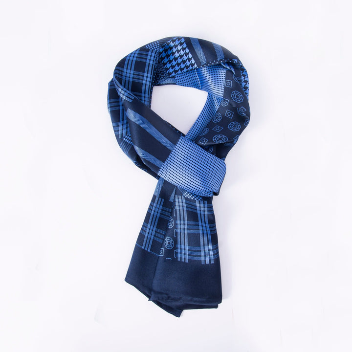 The Mix Pattern Long Silk Scarf from SusanSilk showcases an array of blue shades and intricate designs, such as checks, dots, and geometric shapes. Elegantly arranged in a loop on a white background, this luxurious accessory is crafted from sumptuous silk for a soft and smooth touch.
