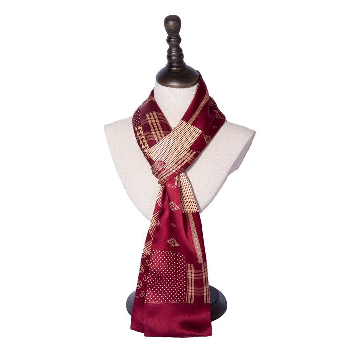 A Mix Pattern Long Silk Scarf by SusanSilk, featuring a red and gold design, displayed on a white mannequin bust with a dark stand, tied in a simple knot.