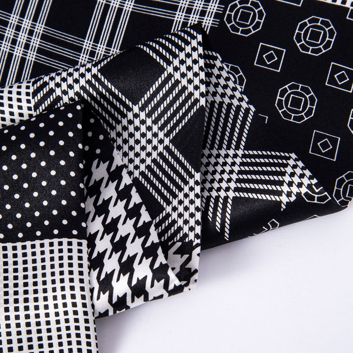 Close-up of various black and white patterned textiles overlapping each other, featuring polka dots, houndstooth, grid lines, and geometric shapes. Among them, a luxurious piece of the Mix Pattern Long Silk Scarf by SusanSilk stands out with its sleek texture.