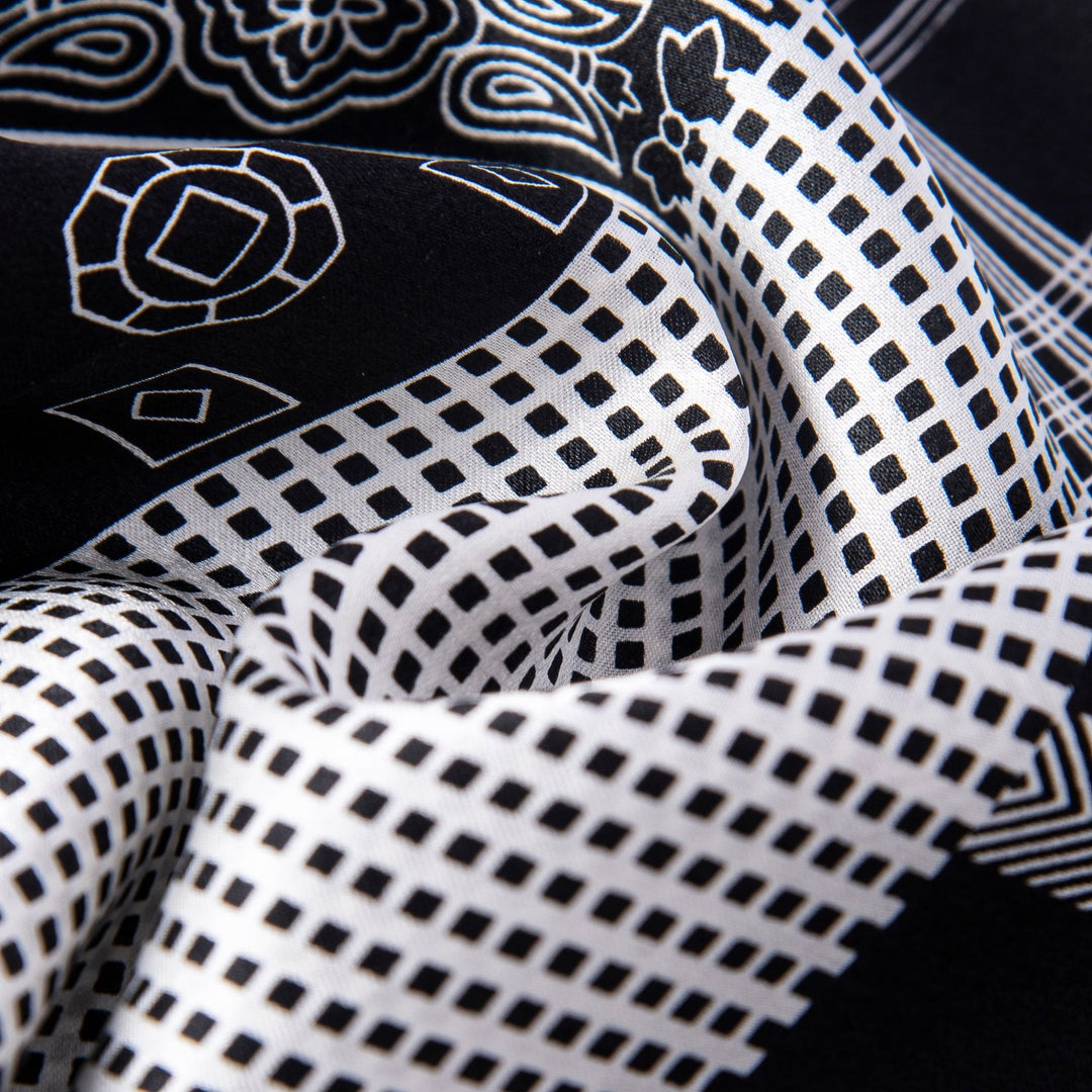 Close-up of mixed pattern men's silk scarf featuring geometric and gemstone designs