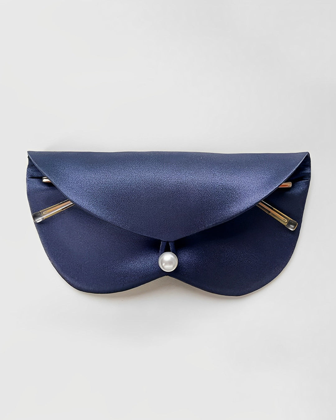 A navy blue clutch bag with a pearl clasp and two gold accents on the front, featuring luxurious detailing by SusanSilk.