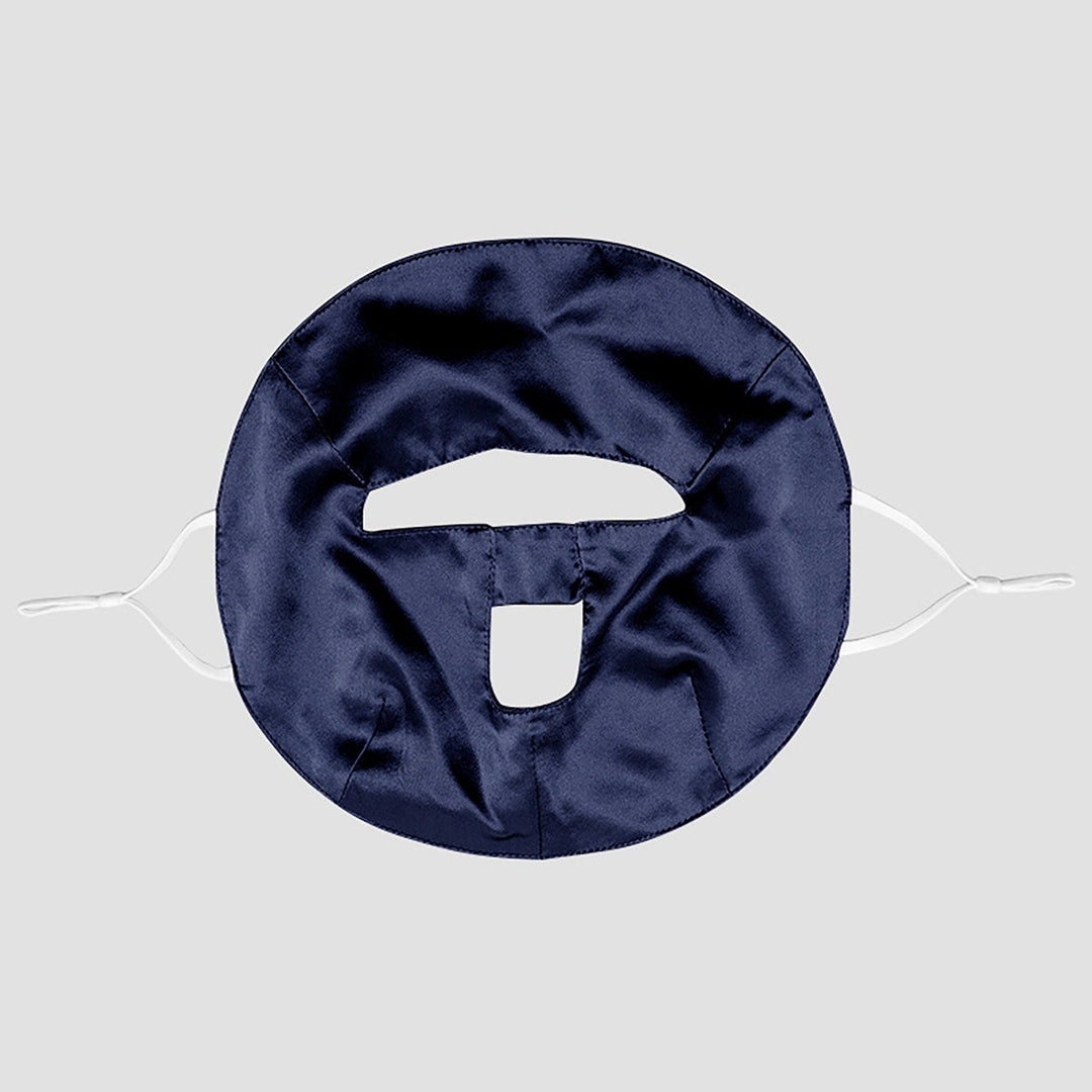 Introducing the Beauty Silk Face Mask by SusanSilk – a dark blue, circular-shaped satin mask featuring two openings, secured by white adjustable straps and crafted from luxurious susansilk for ultimate comfort.