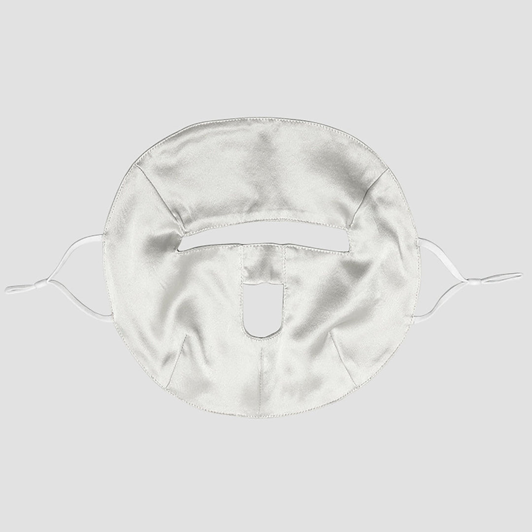 Introducing the Beauty Silk Face Mask by SusanSilk, a white silk fabric mask featuring cutouts for the eyes, nose, and mouth. It comes with ties on both sides to ensure a secure fit.