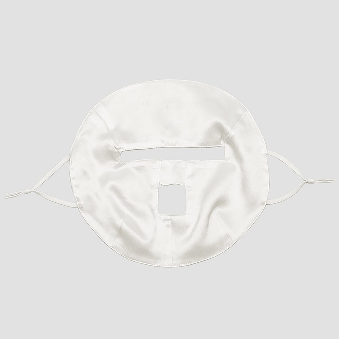 SusanSilk's Beauty Silk Face Mask features a white design with rectangular cutouts for the eyes and mouth, and comes with side straps to secure it onto the face.