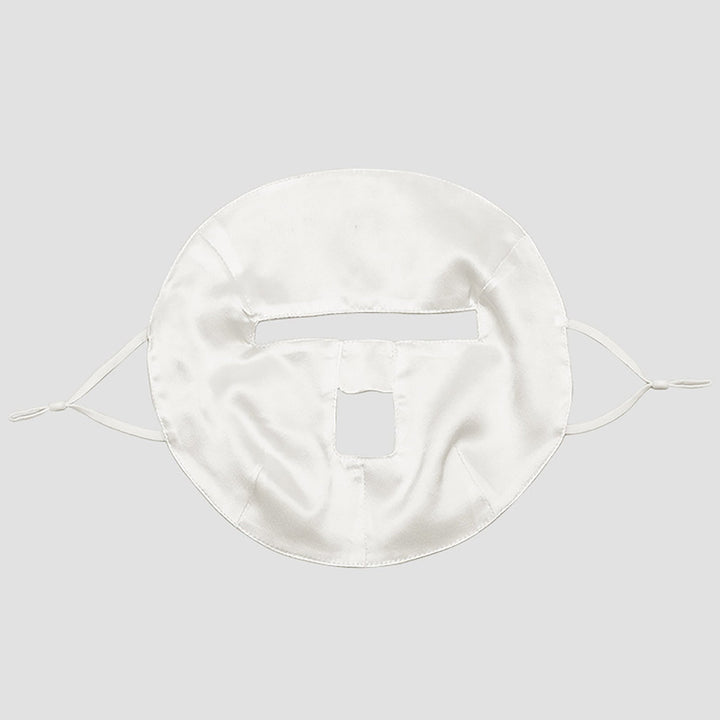 SusanSilk's Beauty Silk Face Mask features a white design with rectangular cutouts for the eyes and mouth, and comes with side straps to secure it onto the face.