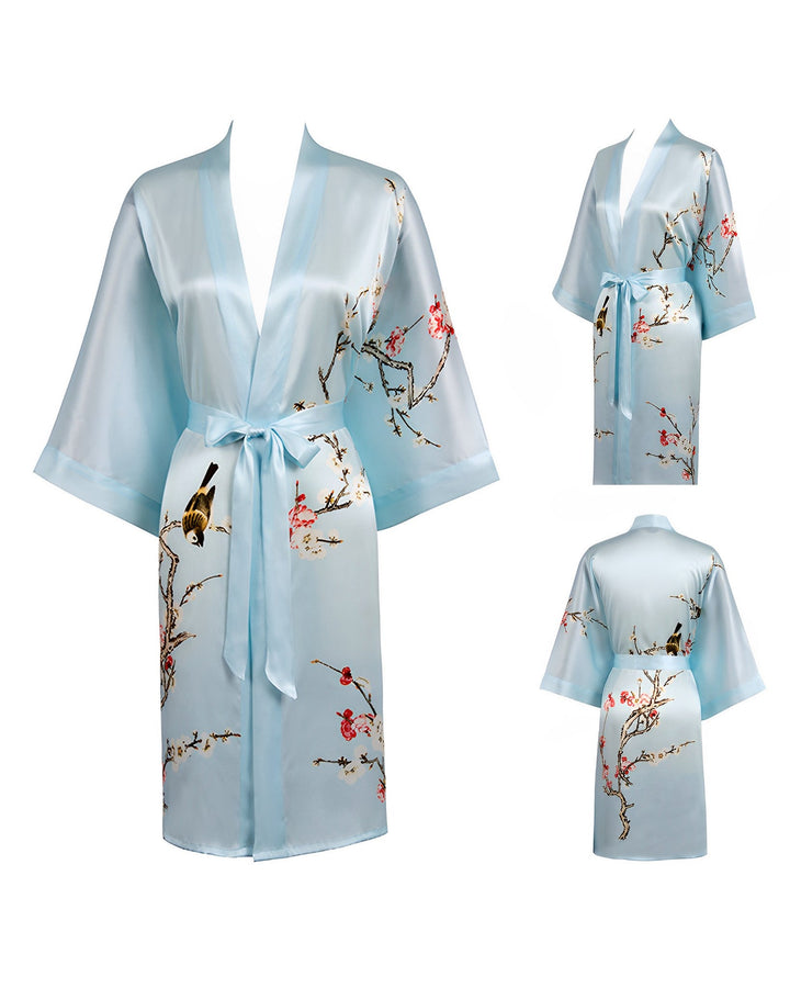 Plum Blossom Short Silk Kimono by SusanSilk in light blue, featuring a floral and bird design, displayed from front, back, and side views.