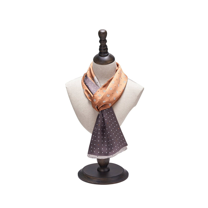 Tri-Colored Gemstone Narrow Long Silk Scarf, featuring shades of peach and brown with small geometric patterns, beautifully displayed on a wooden mannequin bust. Available exclusively from SusanSilk.